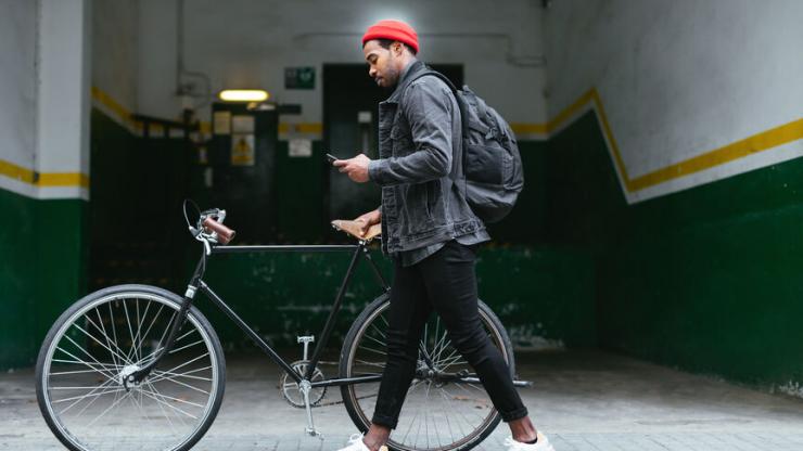 man with bike looking at phone
