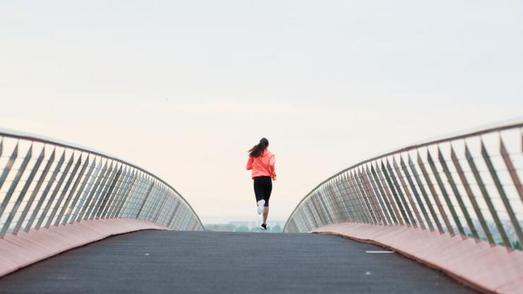 woman running on the bridge