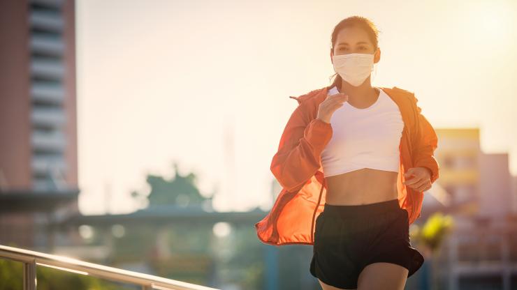 Woman running outside with mask on