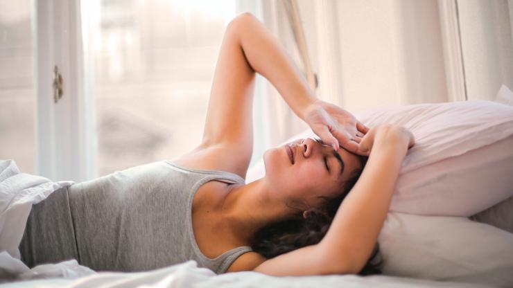 woman in bed looking distressed
