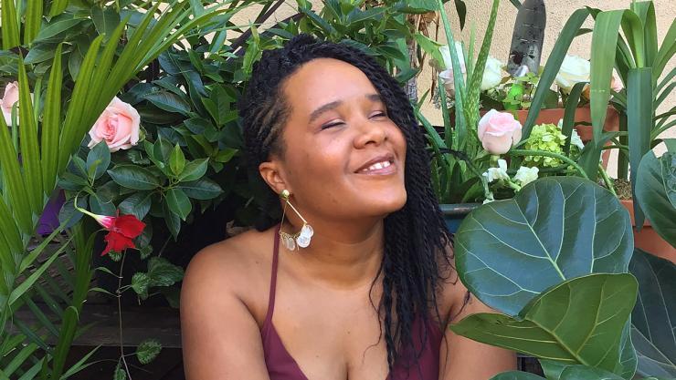 Niambi Cacchioli smiling in a garder