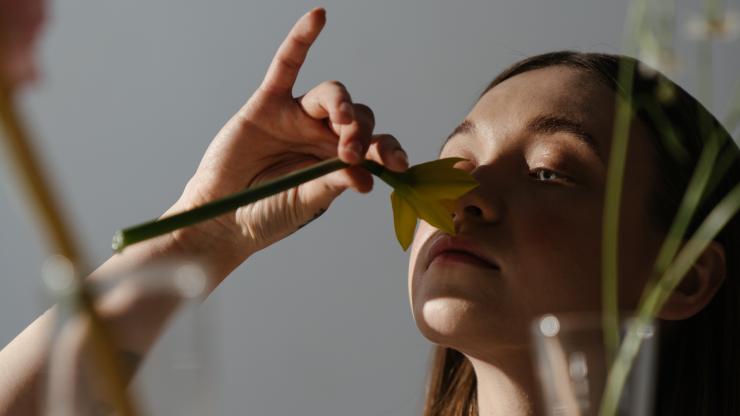 Woman smells a daffodil